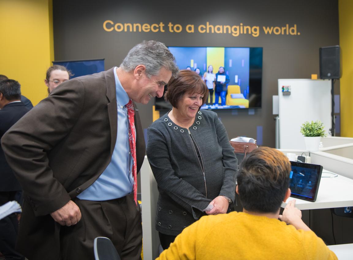 Digital Technology Center Man and woman looking at tech demo on tablet